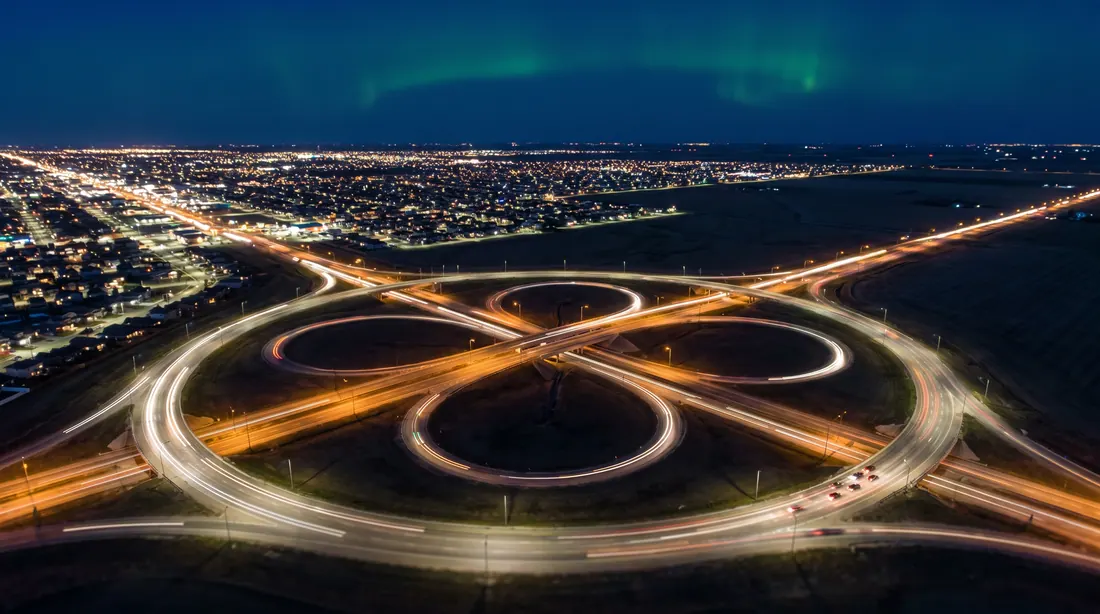 Ring-road interchange at night, seen from above