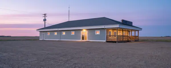 Kiinu Oasis Gaming Centre on the prairie at dusk